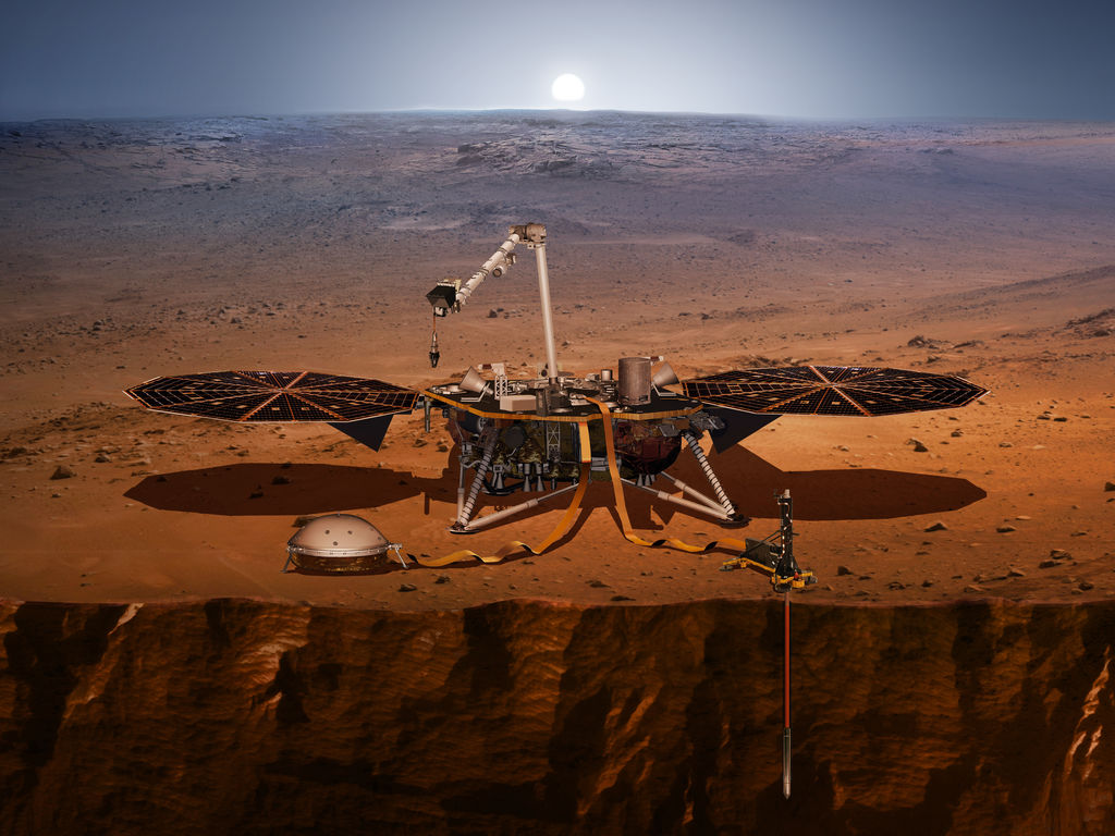 Esta es una representación de la nave InSight en la superficie marciana con uno de sus instrumentos desplegados por el brazo robótico del módulo de aterrizaje y una sonda debajo de la superficie.