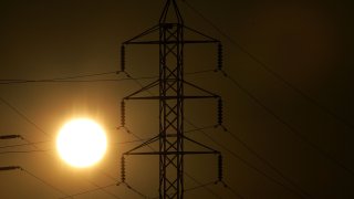 Power towers are seen as the sun sets.