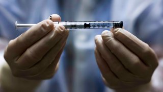 Rocky Mountain Regional VA Medical Center investigational pharmacy technician Sara Berech holds a dose of the Johnson & Johnson COVID-19 vaccine before it is administered in a clinical trial on December 15, 2020 in Aurora, Colorado. The Johnson & Johnson vaccine could be submitted for emergency use by late January and is the only vaccine among leading candidates given as a single dose.