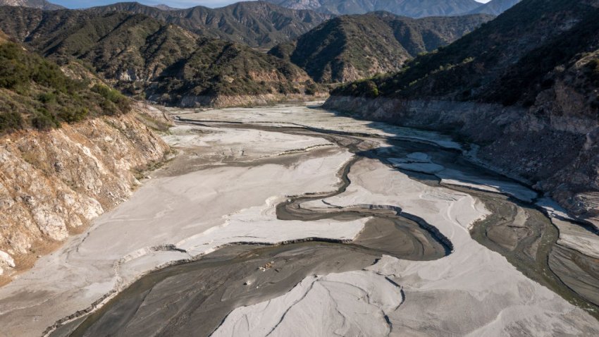 AZUSA, CA – APRIL 8: In an aerial view, the San Gabriel River and the exposed lakebed of the San Gabriel Reservoir are seen in the third week of spring as another year of drought develops throughout the West, on April 8, 2021 in the San Gabriel Mountains near Azusa, California. Precipitation was extremely low in Los Angeles County this winter with no measurable rain recorded in downtown Los Angeles during the month of February, which is the height of the rainy season. As native vegetation continues to grow drier and more flammable each month, fire officials expect another devastating season of massive wildfires. Historically, there is little chance of rain until late 2021. (Photo by David McNew/Getty Images)