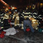Firefighters tend to victims of three-alarm fire in apartmen