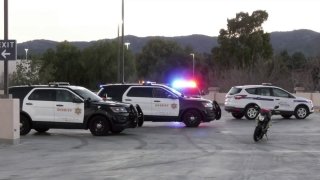 A woman riding a motorcycle was killed after losing control and falling from a Santa Clarita shopping center parking garage.