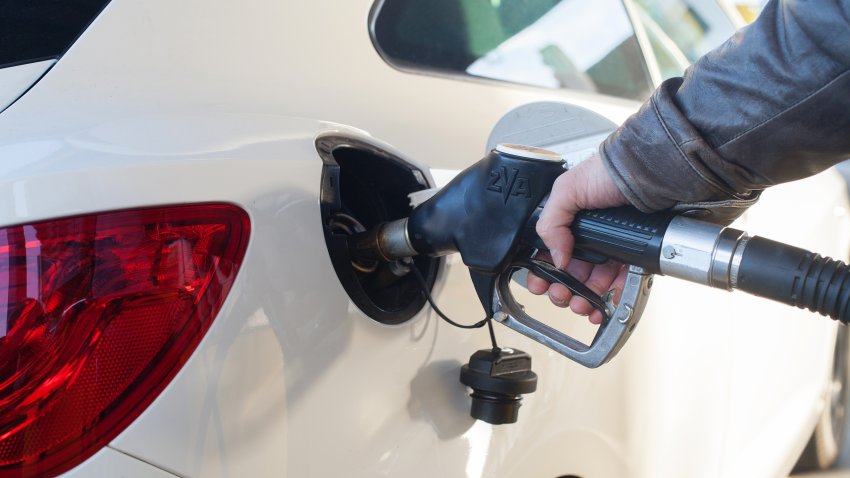 a white new car at gas station