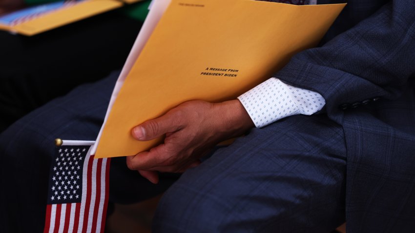 NEW YORK, NEW YORK – JUNE 14: A person holds a welcome packet during a naturalization ceremony on the Wavertree on June 14, 2023 in New York City. U.S. Citizenship and Immigration Services and the South Street Seaport Museum celebrated Flag Day by welcoming 20 new U.S. citizens by hosting a naturalization ceremony aboard the 1885 Tall Ship Wavertree. The 20 candidates were from 17 countries and 5 of the candidates are current or former members of the U.S. Military. (Photo by Michael M. Santiago/Getty Images)