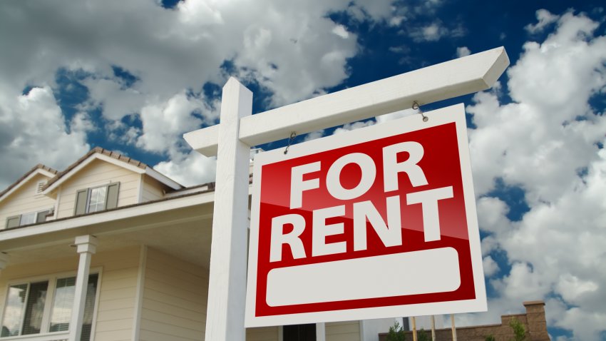 Left Facing Red For Rent Real Estate Sign in Front of Beautiful House.