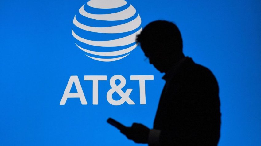 A visitor walks past US multinational telecommunications AT&T logo at the Mobile World Congress (MWC), the telecom industry’s biggest annual gathering, in Barcelona on February 27, 2023. (Photo by Pau BARRENA / AFP) (Photo by PAU BARRENA/AFP via Getty Images)