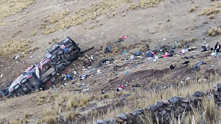 EDITORS NOTE: Graphic content / Dead bodies and debris lie on a hillside next to a wrecked bus that plunged down a ravine on a remote site in the Andes, Peru, on July 16, 2024. A bus plummeted into a ravine in southern Peru, killing at least 21 people and wounding another 20, police said Tuesday. The bus with more than 40 occupants was headed for the Andean region of Ayacucho from Lima when it veered off a cliff about 200 meters (656 feet) high in the early morning hours, highway safety division director Jhonny Valderrama said on RPP radio. (Photo by STRINGER / AFP) (Photo by STRINGER/AFP via Getty Images)