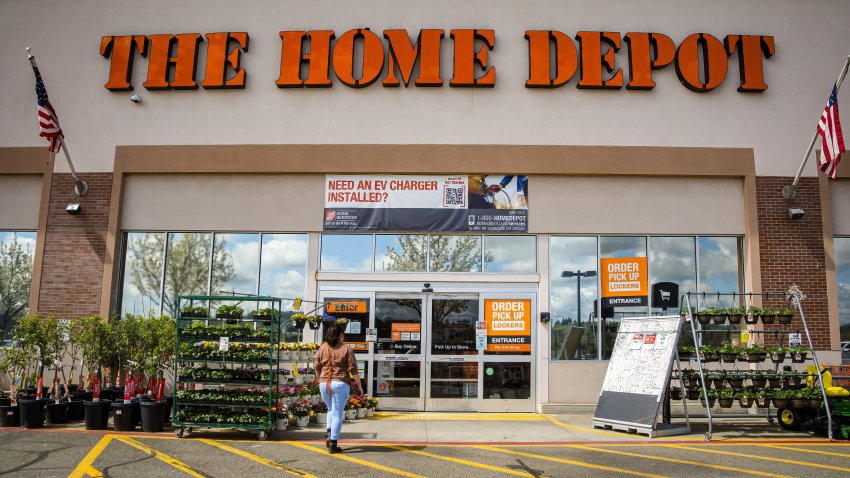 Auburn, CA, U.S.A. – March 25, 2024: Photo of the front entrance of a Home Depot that includes nursery plants, and a sign about EV charger installation.