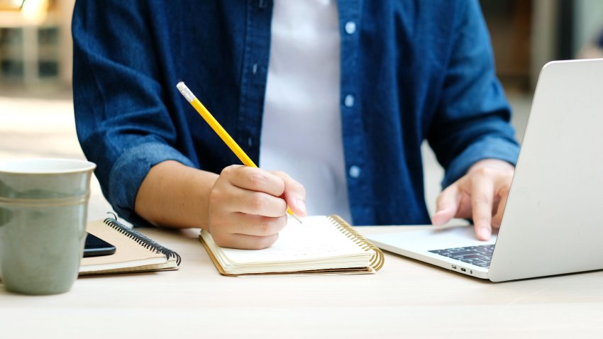 Online class, Student writing on notebook while study at home, Adult man doing online lesson by using laptop computer, Digital technology education, Work from home