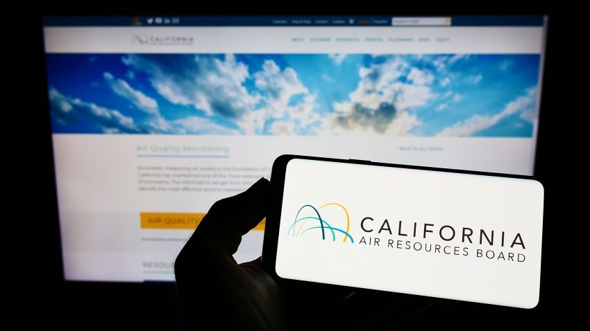 Stuttgart, Germany – 08-27-2022: Person holding mobile phone with logo of California Air Resources Board (CARB) on screen in front of web page. Focus on phone display. Unmodified photo.