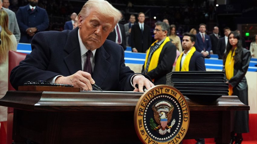 President Donald Trump signs an executive order