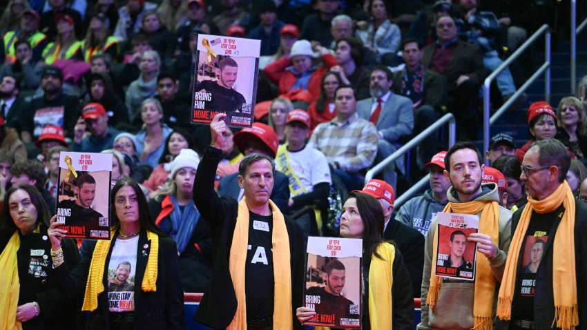Family of hostages hold their photos as special