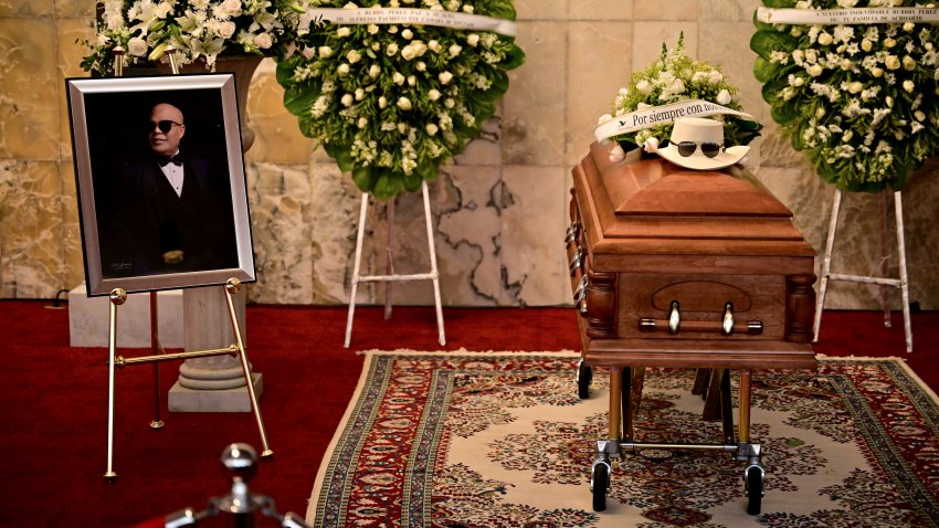 A picture and coffin of famed merengue singer Rubby Perez, who died after the roof of the Jet Set nightclub where he was performing collapsed, is seen during his wake organized by the Minister of Culture at the National Theatre in Santo Domingo on April 10, 2025. The death toll in the collapse has reached 218, security forces reported, as they concentrate on finding the last bodies in the area of the tragedy. More than 500 people were injured in the incident. (Photo by Martin BERNETTI / AFP) (Photo by MARTIN BERNETTI/AFP via Getty Images)