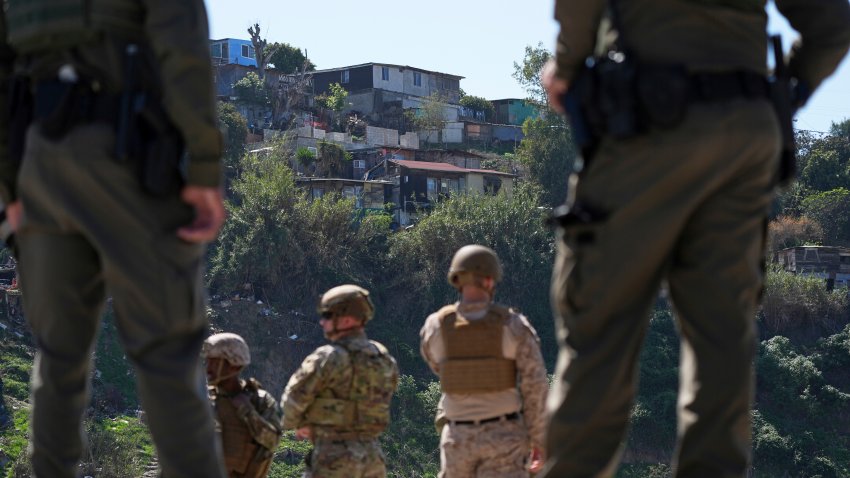 ARCHIVO – Agentes de la Patrulla Fronteriza y miembros del ejército miran hacia Tijuana, México, mientras se encuentran entre dos muros fronterizos, el 21 de marzo de 2025, en San Diego. (AP foto/Gregory Bull, archivo)