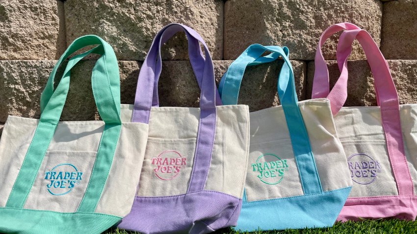Four pastel-colored Trader Joe's mini canvas tote bags lined up in a row.